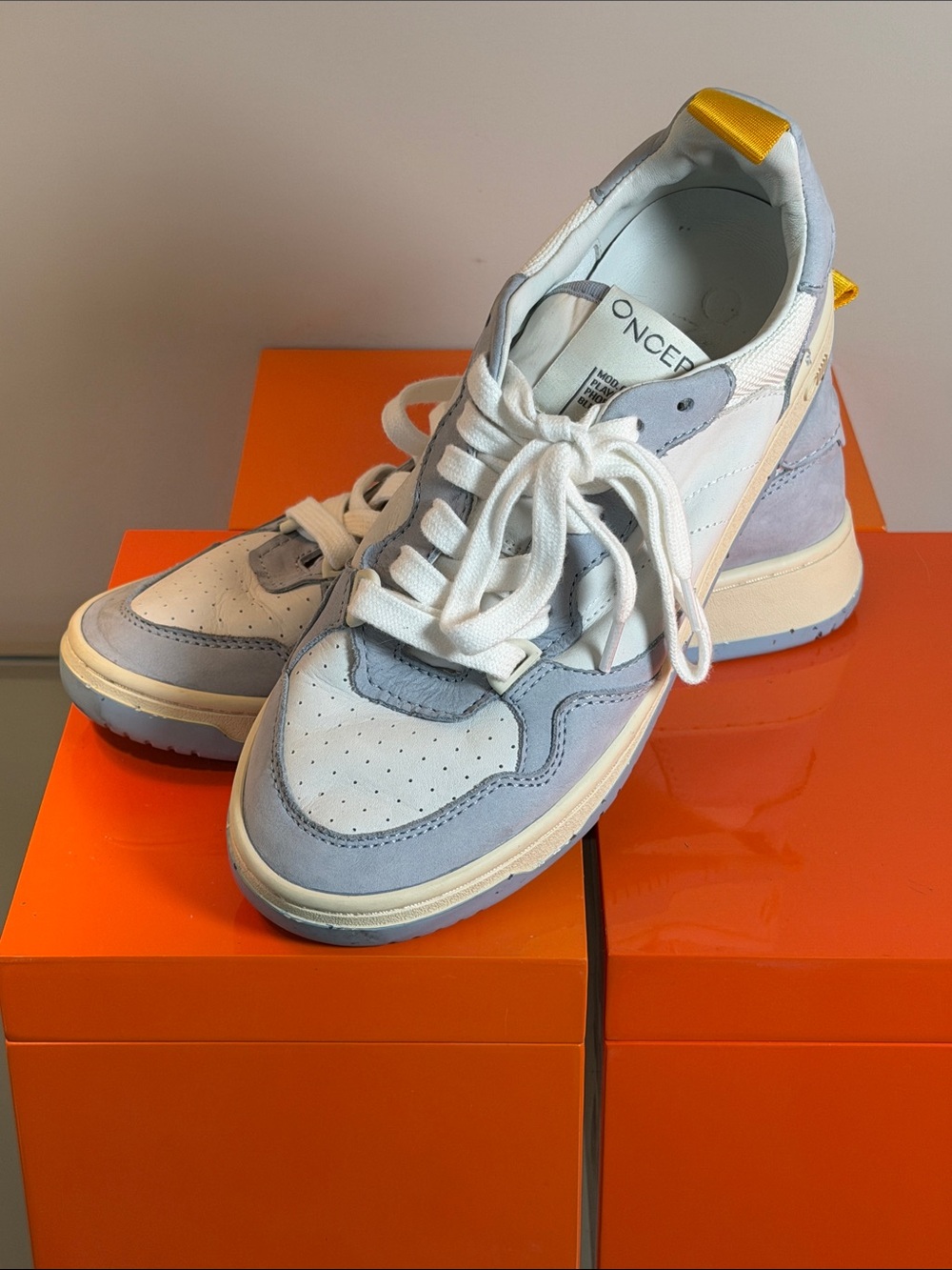 Oncept White & Light Blue Leather Sneakers with Yellow Heel Tab.